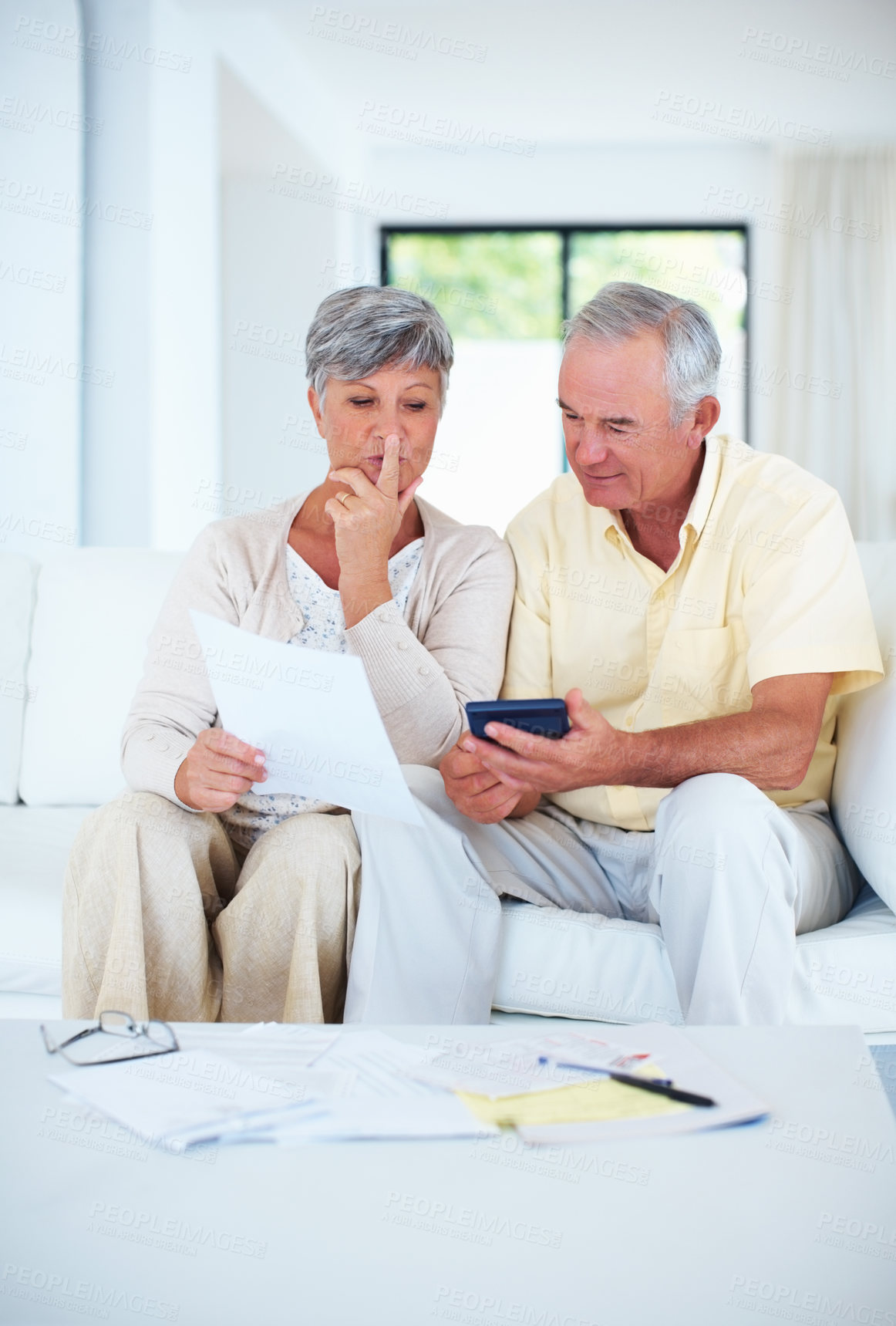 Buy stock photo Senior, couple and documents with calculator in home with budget planning, asset management and discussion. Elderly, people and thinking on sofa with paperwork for pension funding, bills and banking