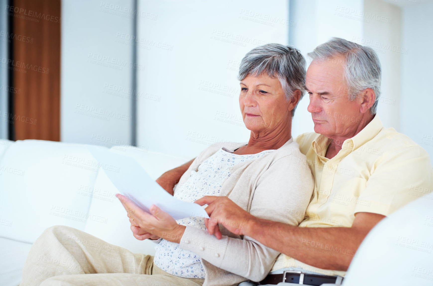 Buy stock photo Mature couple, documents and checking with bills for budget planning, finance or pension fund at home. Elderly, man and woman with paperwork for expenses, mortgage or invoice on couch at house
