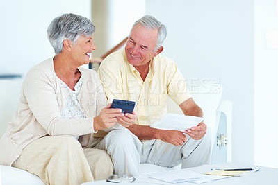 Buy stock photo Senior, couple and finance documents with calculator on sofa for budget planning, asset management or mortgage payment. Elderly, people or happy in home with paperwork for investment account or bills