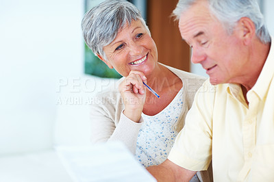 Buy stock photo Smiling mature woman and man calculating house bills