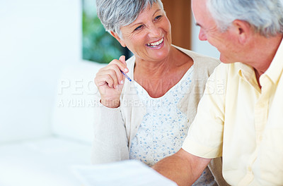 Buy stock photo Cheerful mature woman and man calculating house bills