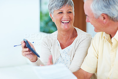 Buy stock photo Happy mature woman and man calculating house bills at home