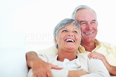 Buy stock photo Senior couple, happy and hug on sofa for relax, bonding and love with support, care and together in home. Elderly people, smile and comfort on couch for weekend break, marriage and embrace with trust