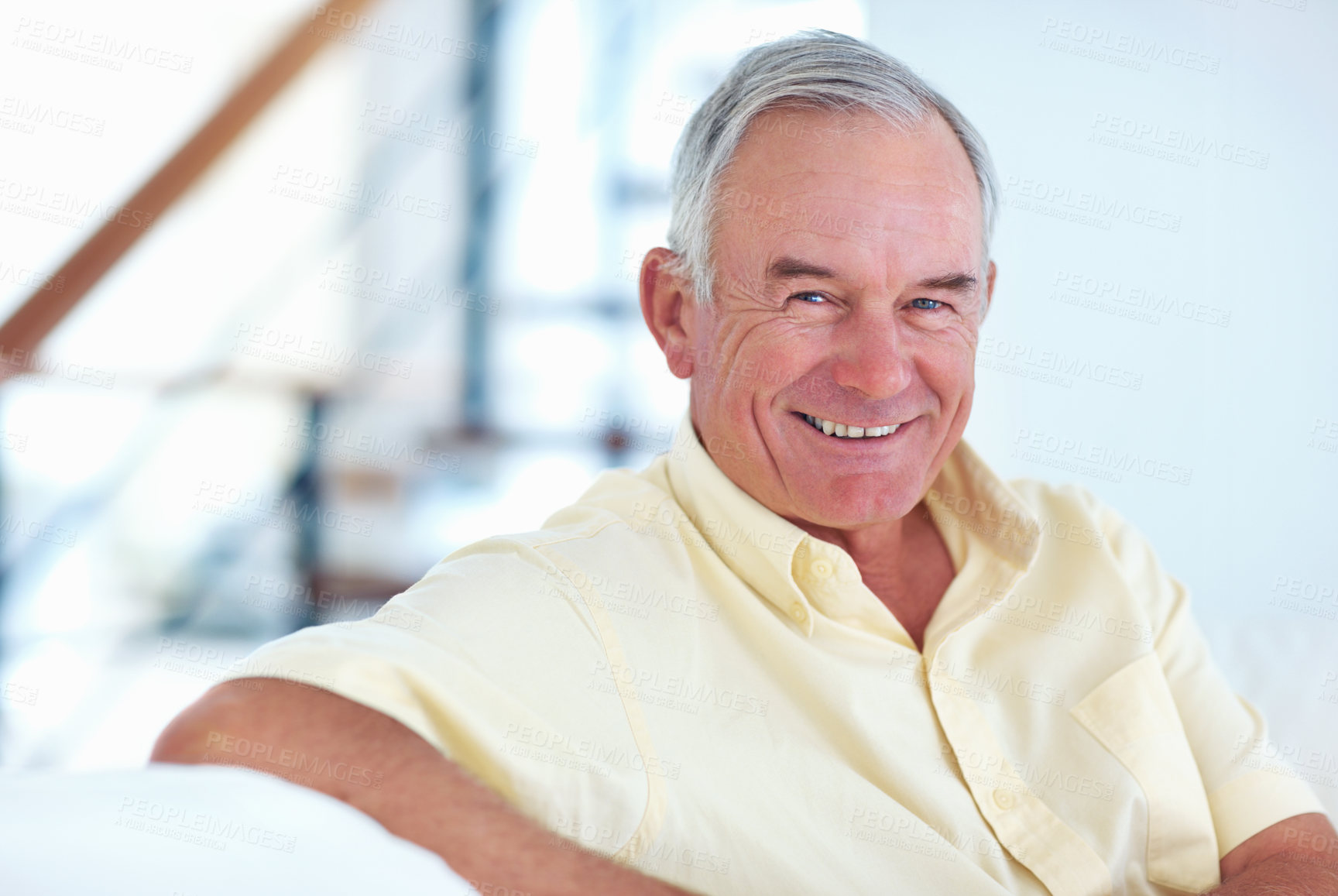 Buy stock photo Portrait of handsome mature man smiling while sitting at home