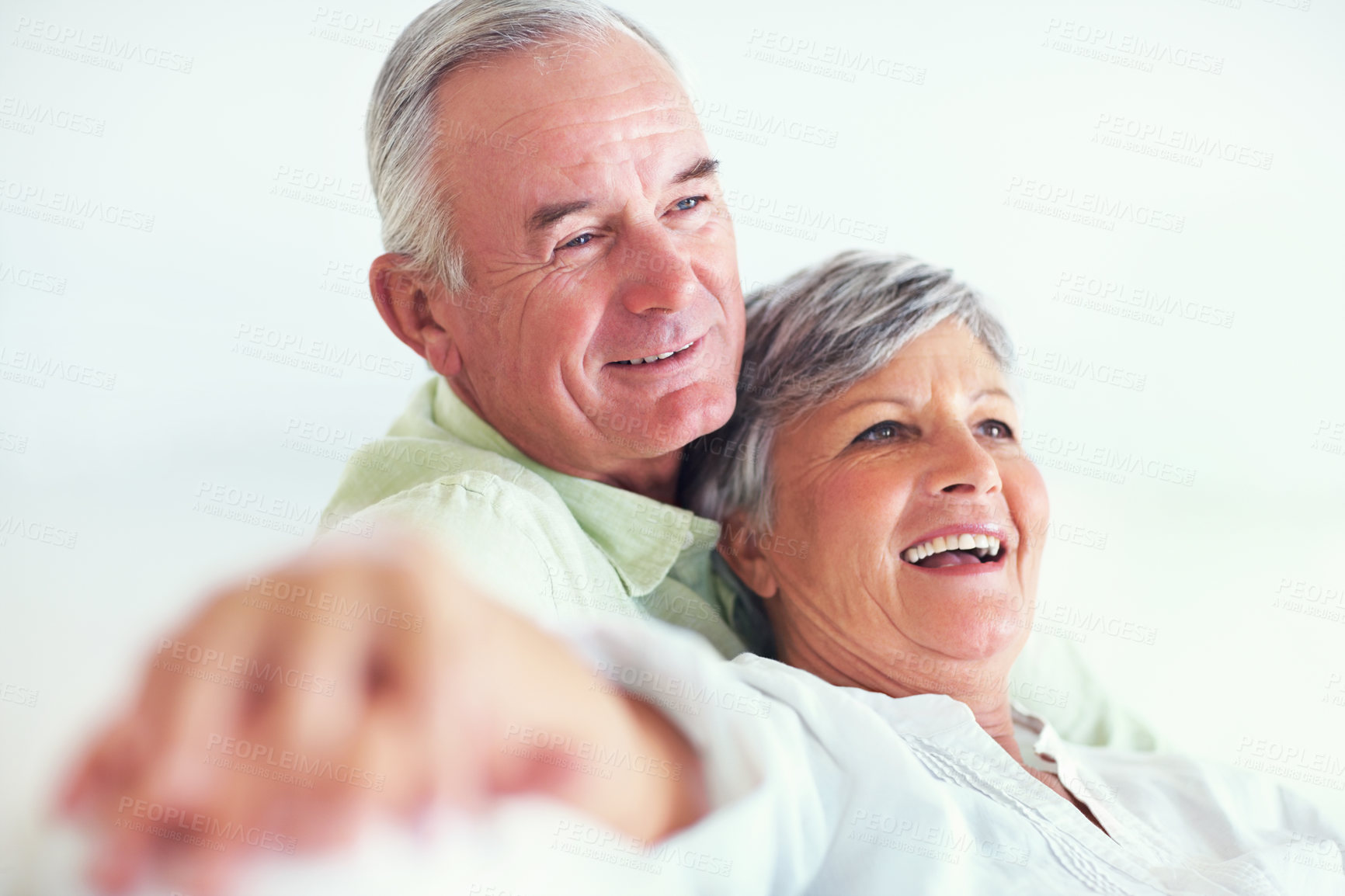 Buy stock photo Elderly couple, happy and hug on sofa for relax, bonding and love with support, care and together in home. Senior people, smile and comfort on couch for weekend break, marriage and embrace with trust