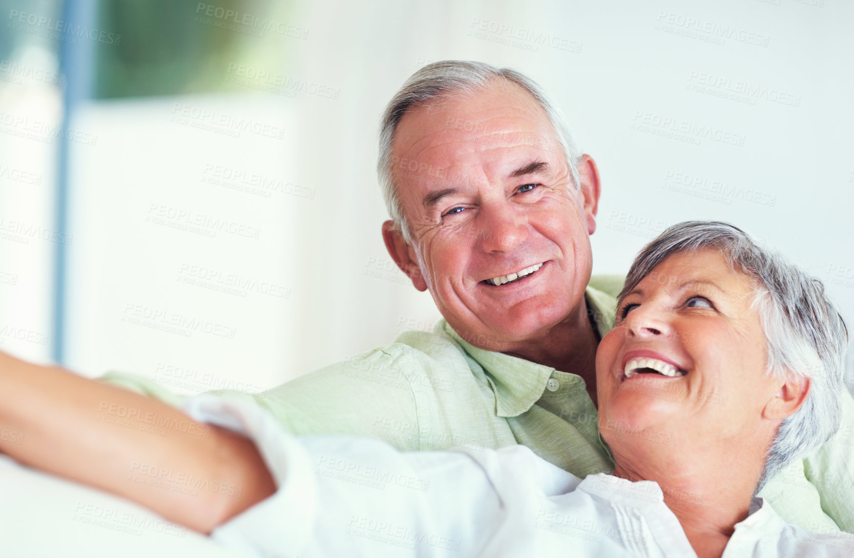 Buy stock photo Senior couple, happy and portrait on sofa for relax, bonding and love with support, care and together in home. Elderly people, smile and happy on couch for weekend, marriage and embrace with trust