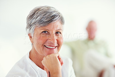 Buy stock photo Closeup portrait of mature woman smiling with blurred man in background
