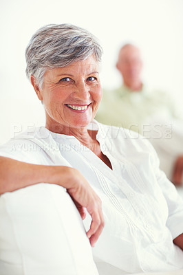 Buy stock photo Portrait of relaxed mature woman smiling with man in background