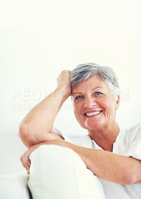 Buy stock photo Portrait of pretty mature woman smiling while relaxing at home