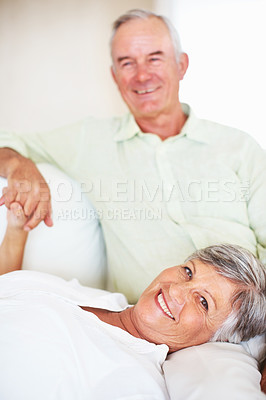 Buy stock photo Senior couple, happy and portrait on sofa for bonding, relax and love with support, care and together in home. Elderly people, smile and comfort on couch for weekend, marriage and embrace with trust