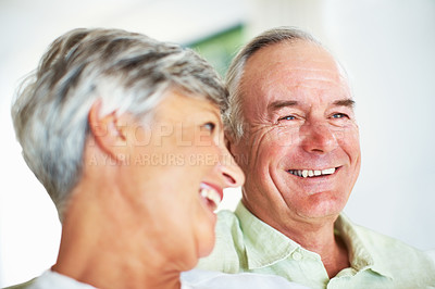 Buy stock photo Senior couple, happy and support on sofa for relax, bonding and love with hug, care and together in home. Elderly people, smile and comfort on couch for weekend break, marriage and embrace with trust