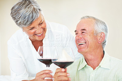 Buy stock photo Elderly couple, wine and toast in home, marriage anniversary and growth in partnership. Happy people, romance and cheers with alcohol glasses for love celebration, milestone and bonding on date