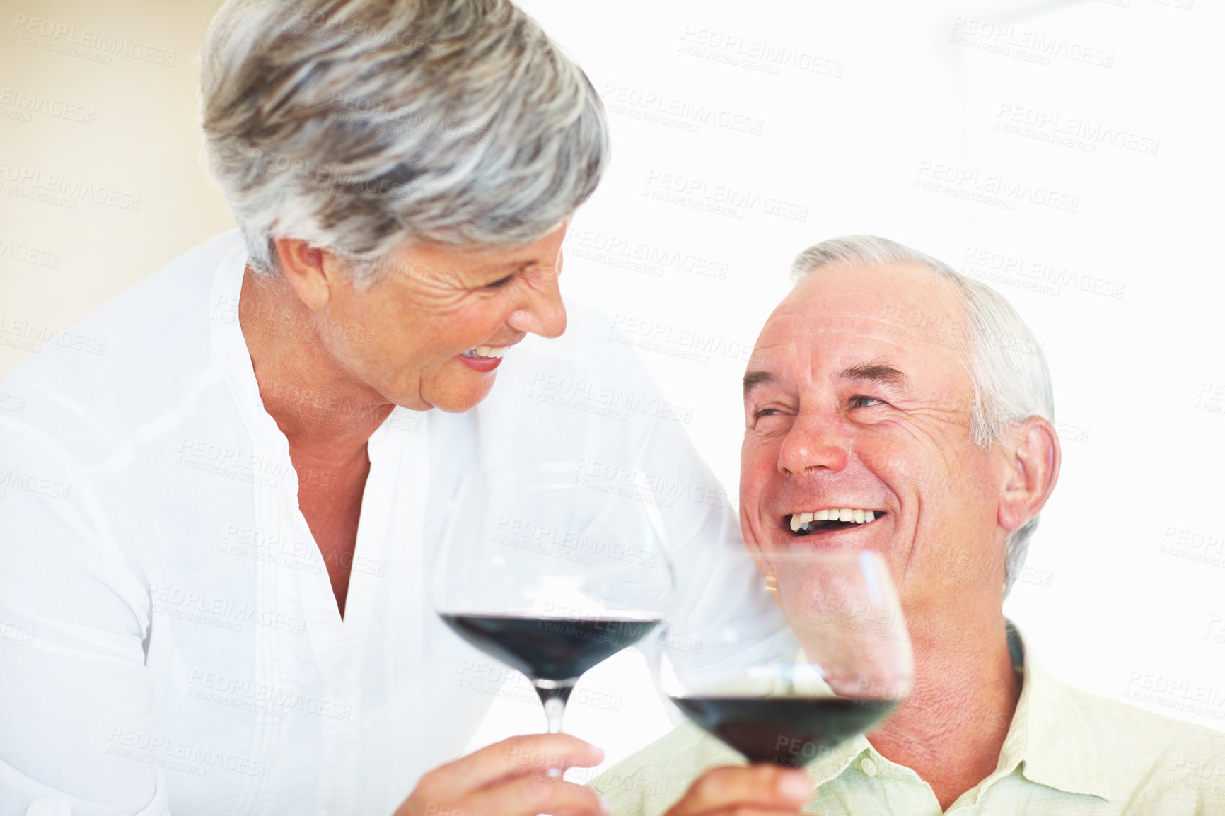 Buy stock photo Senior couple, glasses and toast in home, marriage anniversary and growth in partnership. Elderly people, romance and cheers with red wine for love celebration, happy milestone and bonding on date