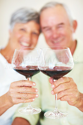 Buy stock photo Mature couple, hands or red wine with glasses for toast, cheers or celebration on date together at home. Closeup, elderly man and woman with drink or beverage for holiday, bonding or romance at house