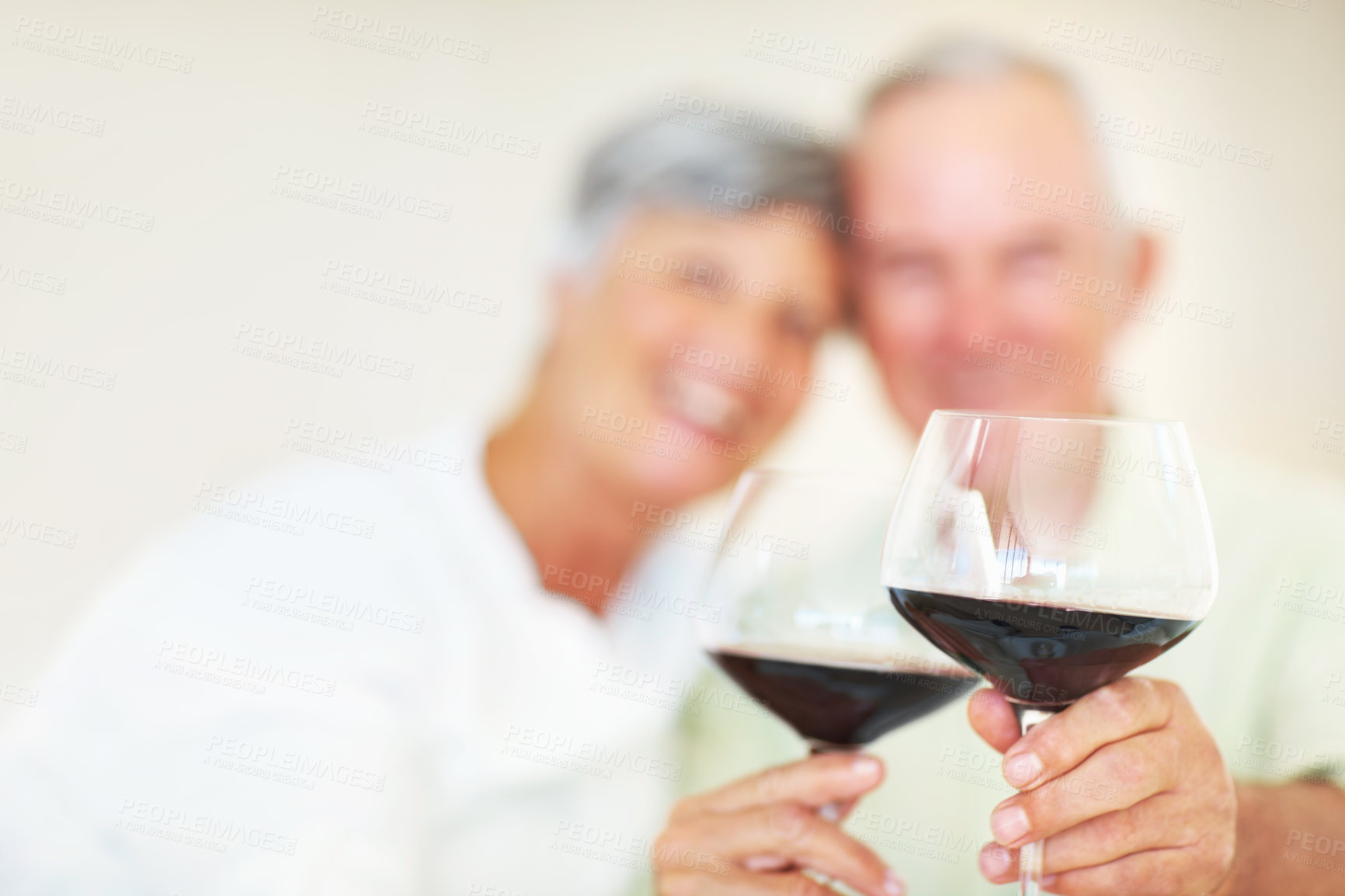 Buy stock photo Old couple, glasses and hands for toast in home, marriage anniversary and growth in partnership. Elderly people, romance and cheers with red wine for love celebration, milestone and bonding on date