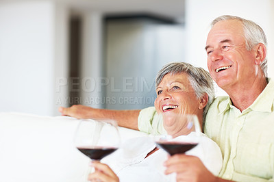 Buy stock photo Senior couple, wine and relax in home, marriage anniversary and growth in partnership. Elderly people, romance and laughing with alcohol glasses for love celebration, milestone and bonding on date