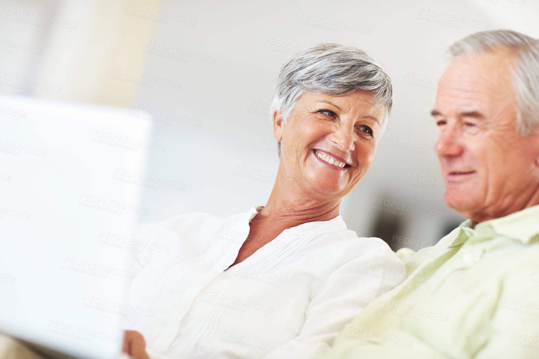 Buy stock photo Senior couple, laptop and home for online blog, surfing social media and internet for communication. Elderly people, relax and together for bonding in living room, reading funny ebook and streaming