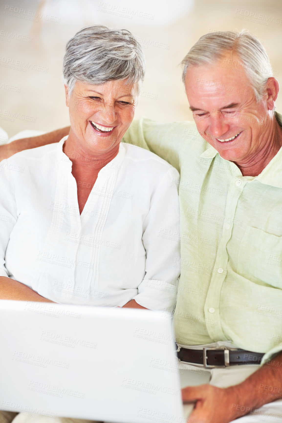 Buy stock photo Senior couple, laptop and home for blog, surfing social media and internet for communication. Elderly people, relax and together for bonding in living room, reading funny ebook and streaming comic