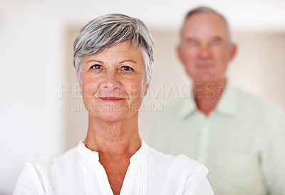 Buy stock photo Home, senior woman and confident in portrait for retirement, comfort and smile with positive attitude. Elderly couple, female person and old man in marriage for commitment, connection and bonding