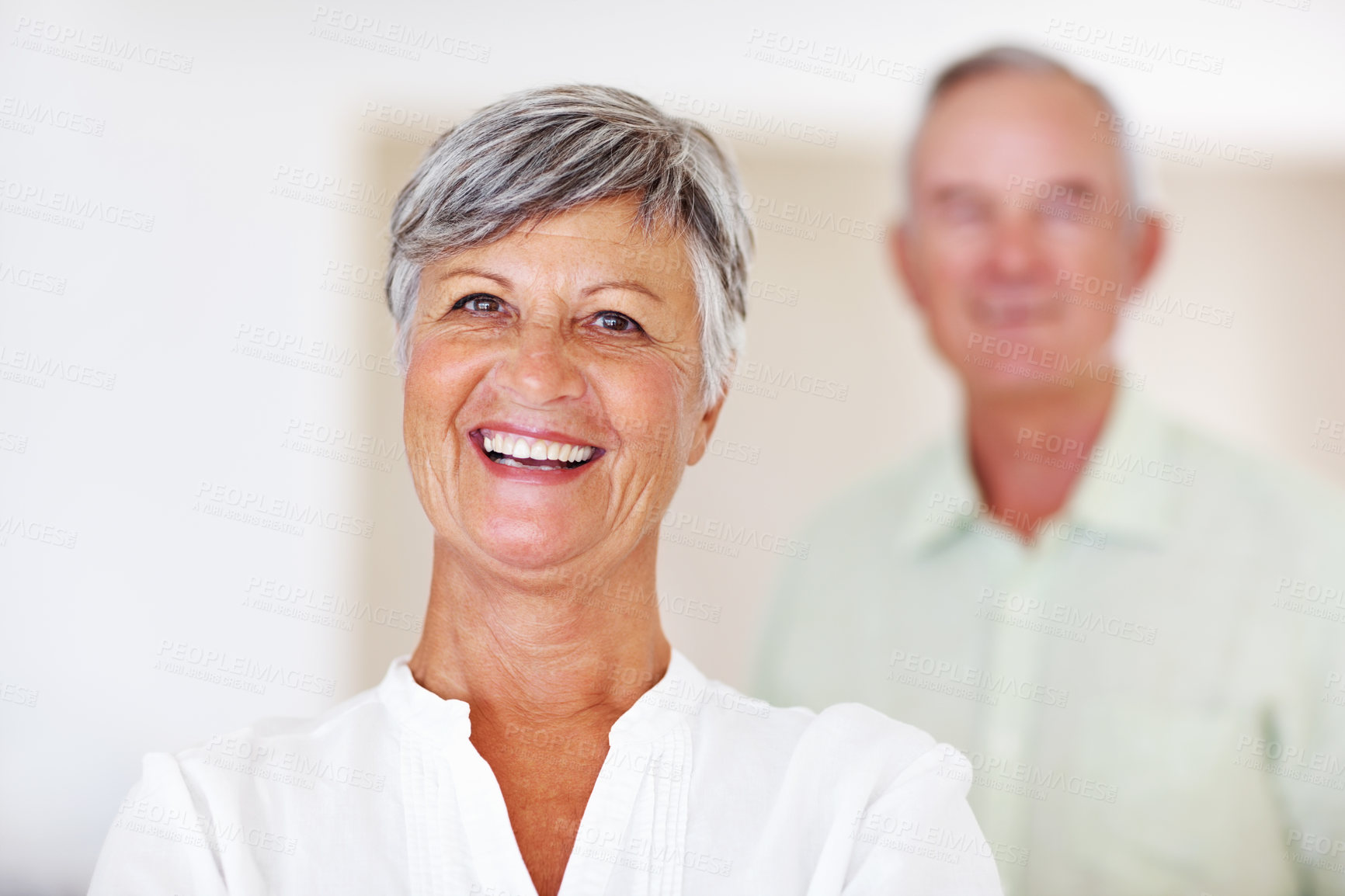 Buy stock photo Home, senior woman and laughing in portrait for retirement, comfort and happiness with positive attitude. Elderly couple, female person and old man in marriage for commitment, connection and bonding