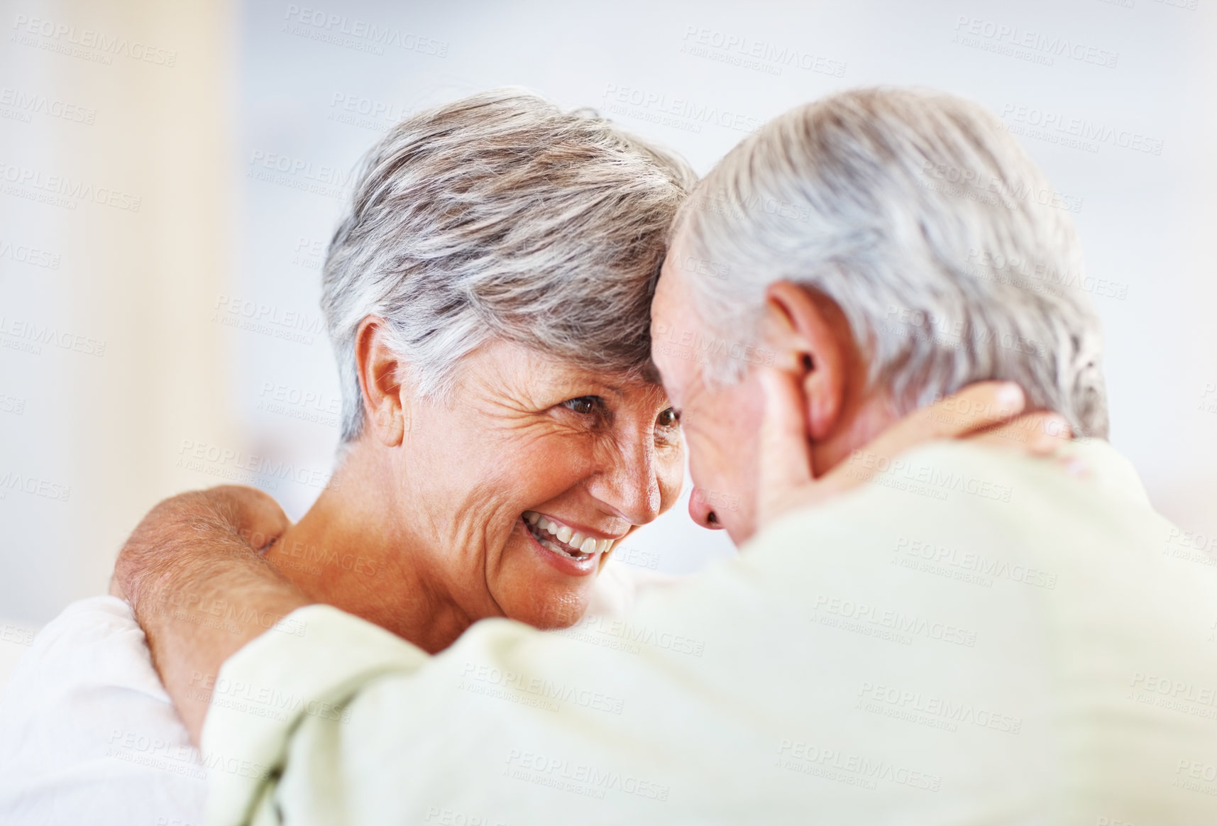 Buy stock photo Senior couple, happy and romance in home for relax, bonding and love with support, care and together. Elderly people, smile and connection in house for weekend break, marriage and embrace with trust