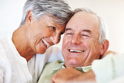 Buy stock photo Senior couple, happy and hug for relax, bonding and love with support, care and together in home. Elderly people, smile and comfort on couch for weekend break, marriage and embrace with relationship