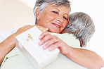Mature couple hugging after sharing gift
