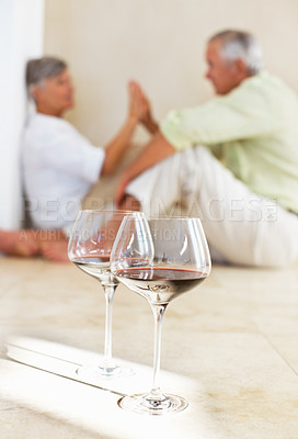 Buy stock photo Senior couple, wine and high five for love, relax and bonding in house with glass, care and support. Man, woman and holding hands in apartment for relationship, marriage or commitment with alcohol