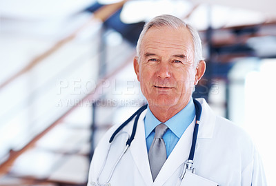 Buy stock photo Portrait of mature male doctor with stethoscope smiling