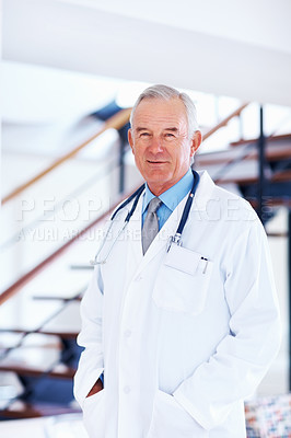Buy stock photo Portrait of mature doctor with stethoscope smiling in hospital