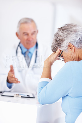Buy stock photo Mature doctor discussing medical report with unhappy patient