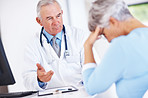 Doctor discussing reports with unhappy patient