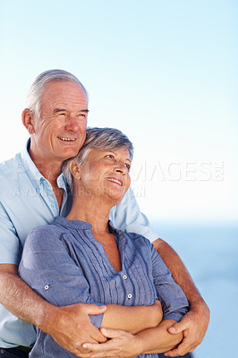 Buy stock photo Loving mature couple spending romantic time outdoors with ocean in background