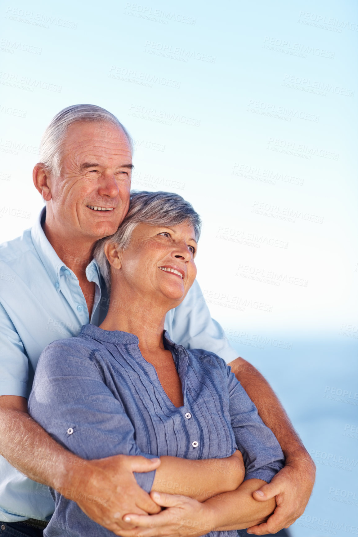 Buy stock photo Mature couple, relax and hug with blue sky for marriage vacation, bonding together and romance outdoor. Smile, people and embracing with mockup for love, travel peace and commitment of relationship