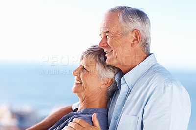 Buy stock photo Romantic mature couple smiling while spending quality time outdoors