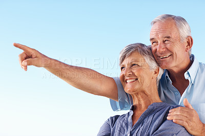 Buy stock photo Happy mature man showing something to beautiful wife while spending time outdoors