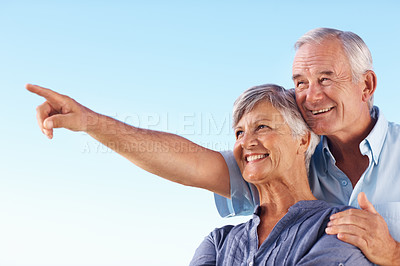 Buy stock photo Happy, couple and point with hug of blue sky for marriage vacation, bonding together and romance outdoor. Smile, people and embracing care for mockup, love and travel view of relationship commitment