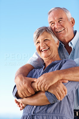 Buy stock photo Couple, happy and embrace with blue sky for marriage vacation, bonding together and romance outdoor. Smile, mature and people with embracing for mockup, love and travel location of relationship trust