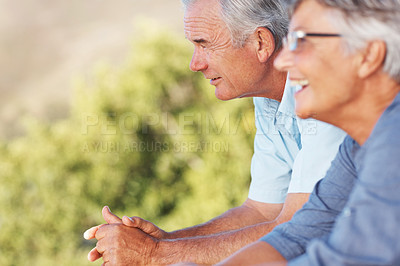 Buy stock photo Focus on smiling mature man enjoying view from balcony with cheerful woman