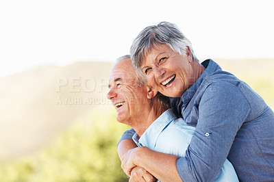 Buy stock photo Portrait of cheerful mature woman smiling while embracing man outdoors