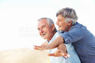 Buy stock photo Happy mature man giving piggyback ride to woman outdoors with arms outstretched