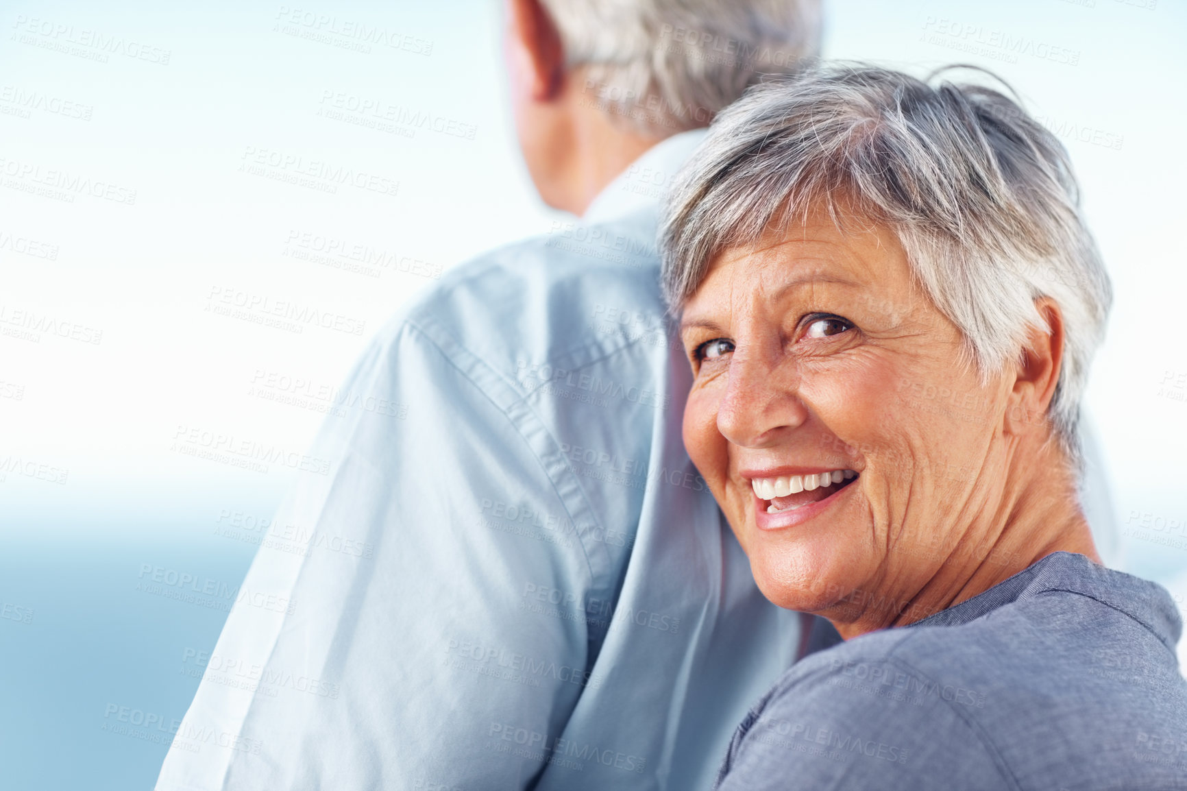Buy stock photo Happy, hug and senior couple with smile, back and bonding for retirement ocean view. Love, embrace and elderly woman with man and romantic date, holiday or vacation together with blue sky in Canada