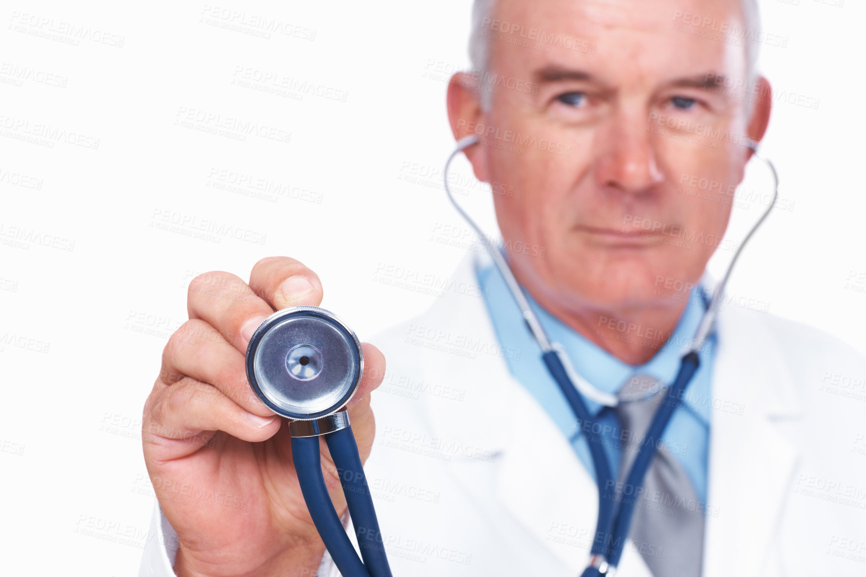 Buy stock photo Portrait of mature male doctor holding stethoscope over white background