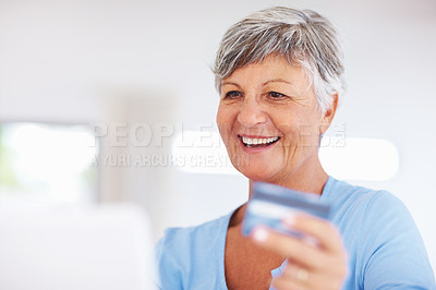 Buy stock photo Smiling mature woman shopping online using laptop and credit card