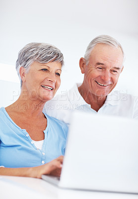 Buy stock photo Happy mature woman and man using laptop at home