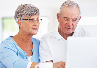 Buy stock photo Mature Caucasian man and woman using laptop at home