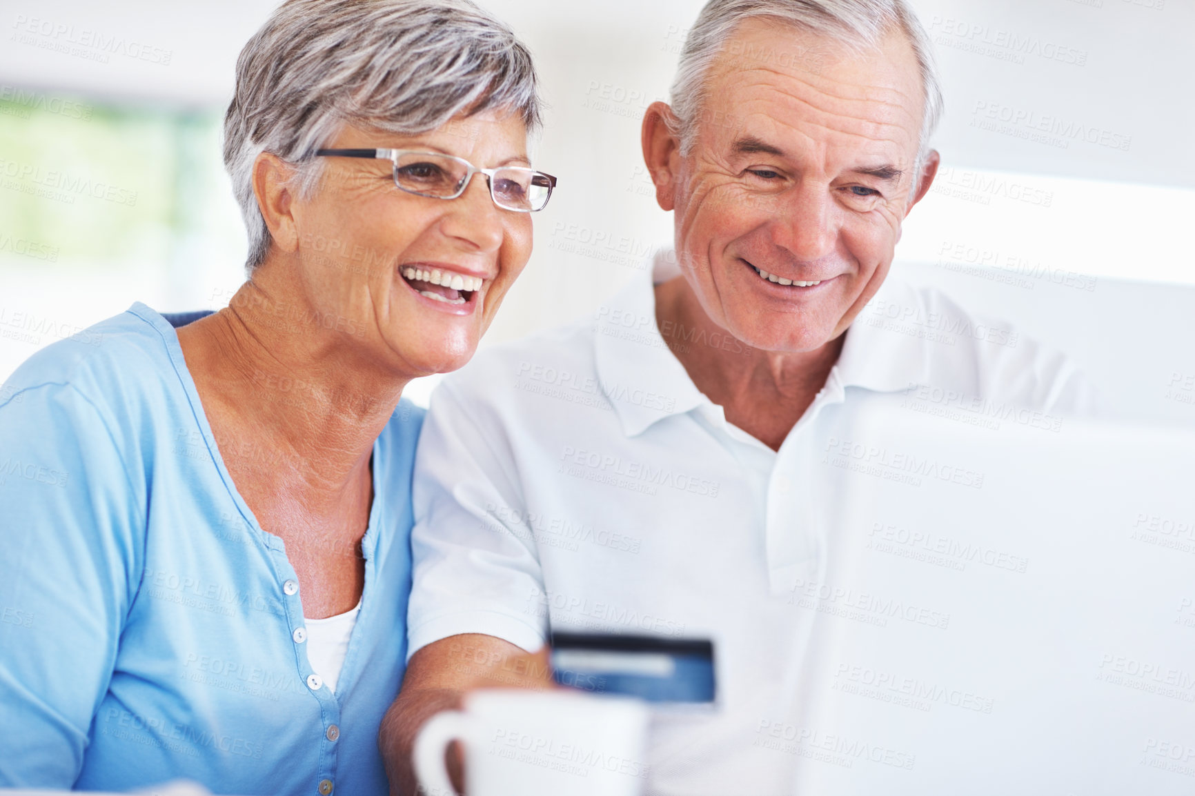 Buy stock photo Elderly couple, laptop and credit card for online shopping, ecommerce and purchase in kitchen. Man, woman and computer for payment, subscription or sales review with home or retirement planning