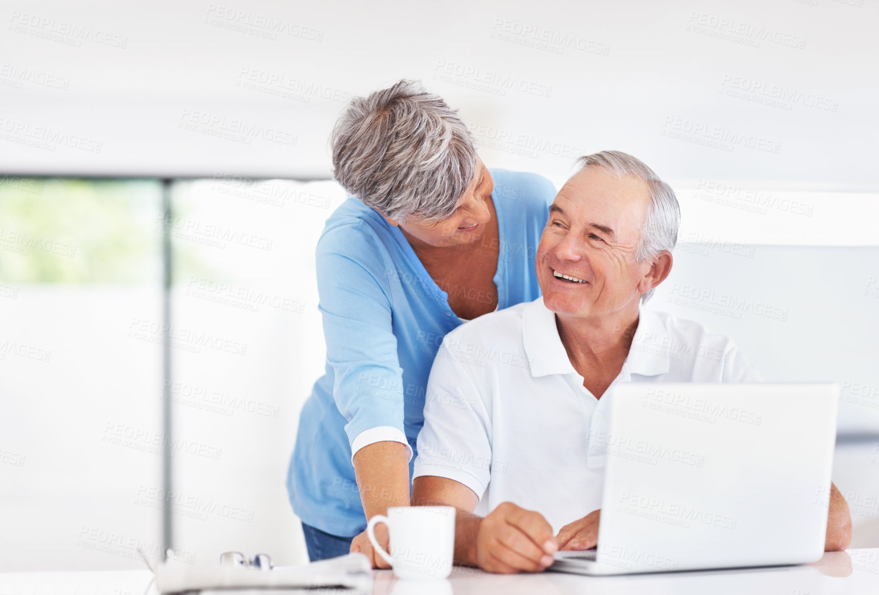 Buy stock photo Senior couple, laptop and happy in kitchen with talking for memory, care and love with connection in home. Elderly man, woman and smile with notification, chat and email with coffee in retirement