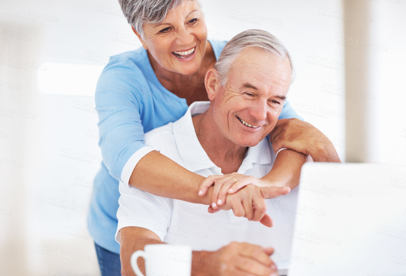 Buy stock photo Senior couple, laptop and hug in kitchen with talk for funny memory, care and love with connection in home. Elderly man, woman and happy with notification, laugh and email with coffee in retirement