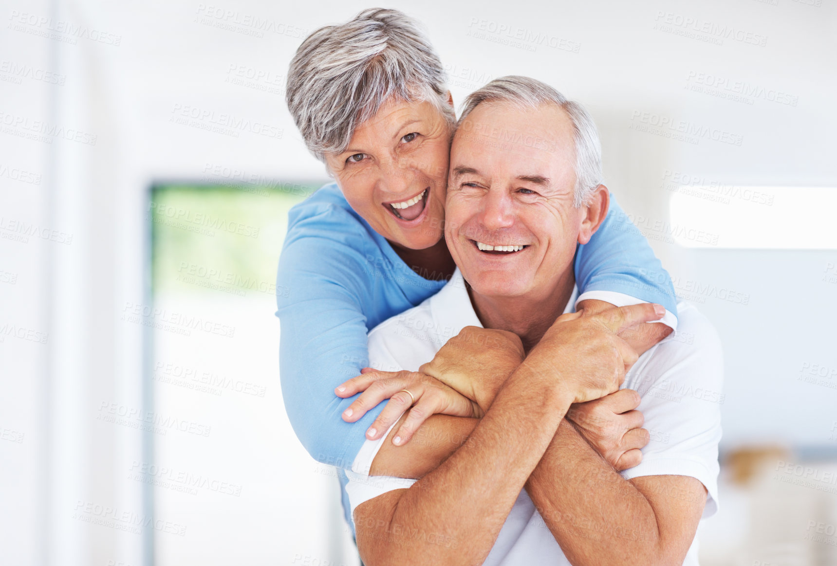 Buy stock photo Kitchen, elderly couple and portrait with embrace for love, connection and bonding together in retirement. Senior people, woman and man with hug in marriage, commitment and security for care at home